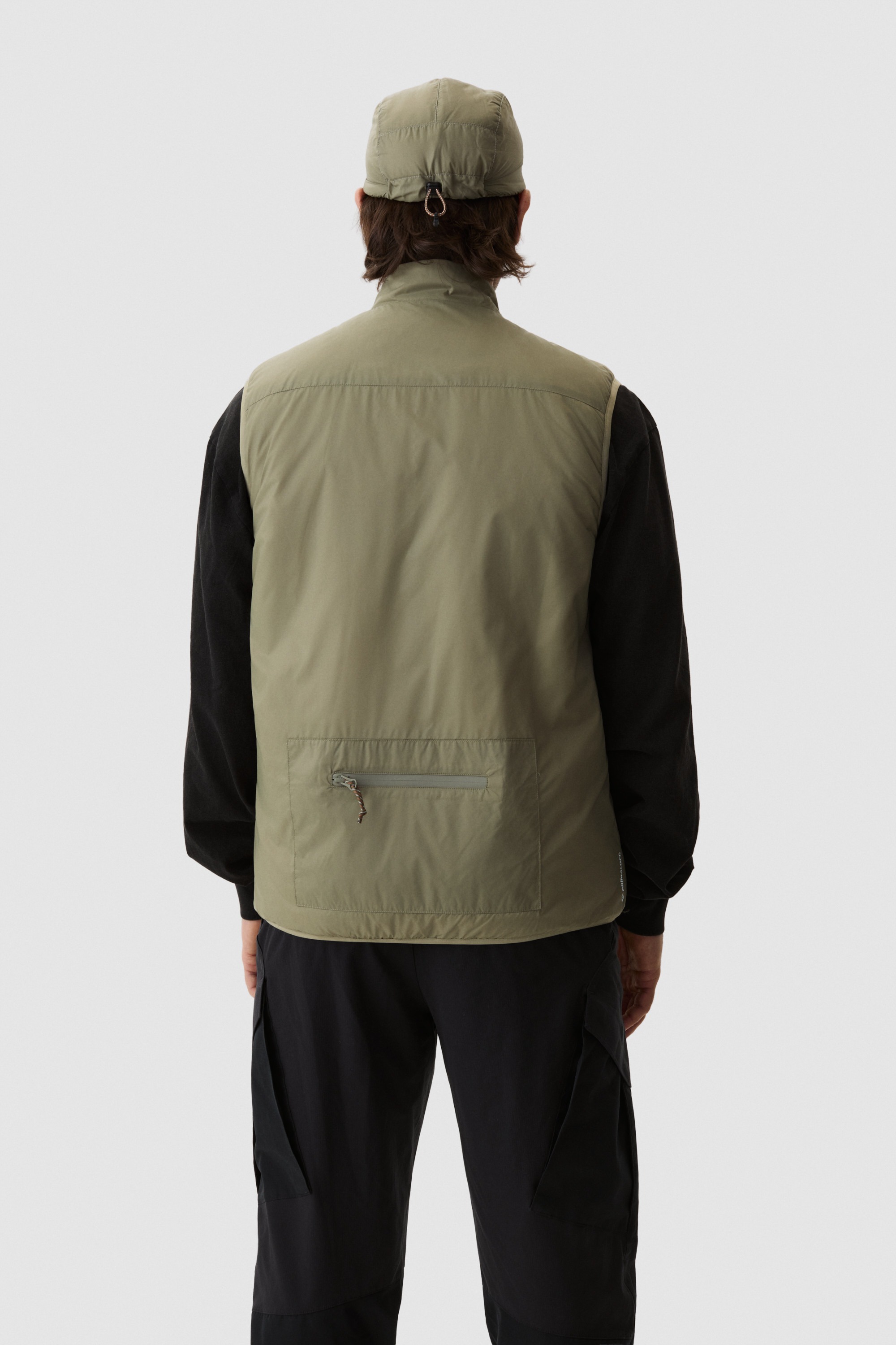 Model wearing Yama Traverse Plain Vest Moss Green