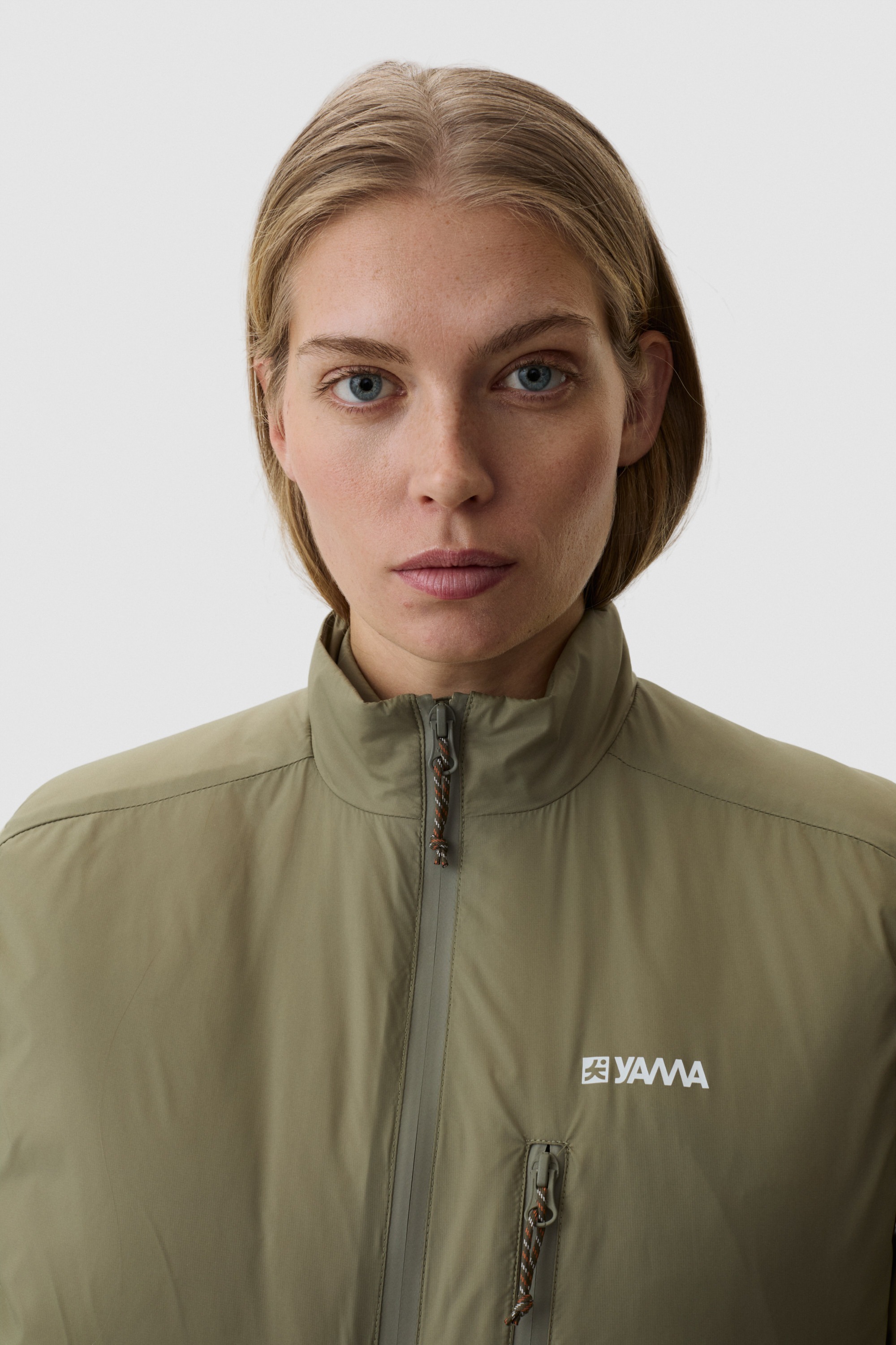 Model wearing Yama Traverse Plain Vest Moss Green