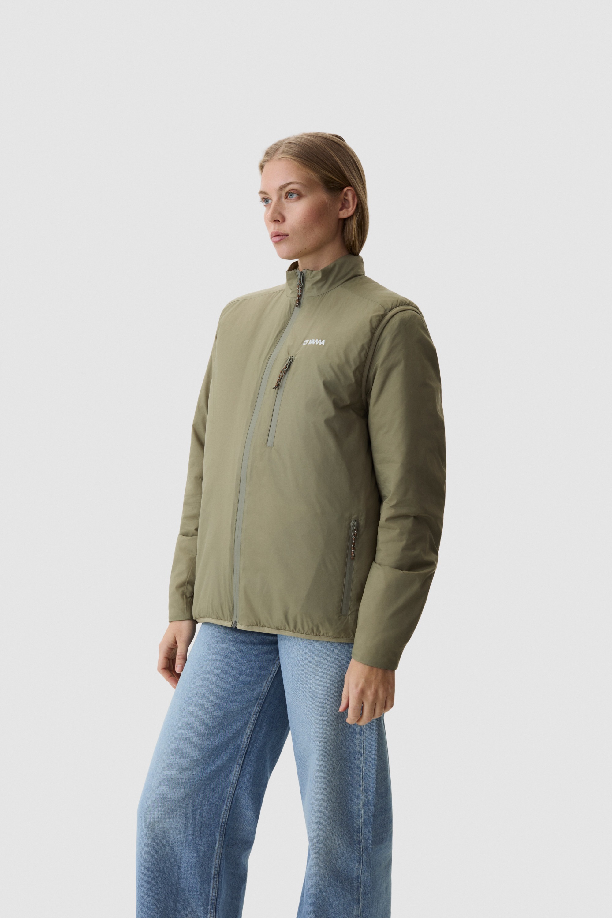 Model wearing Yama Traverse Plain Vest Moss Green