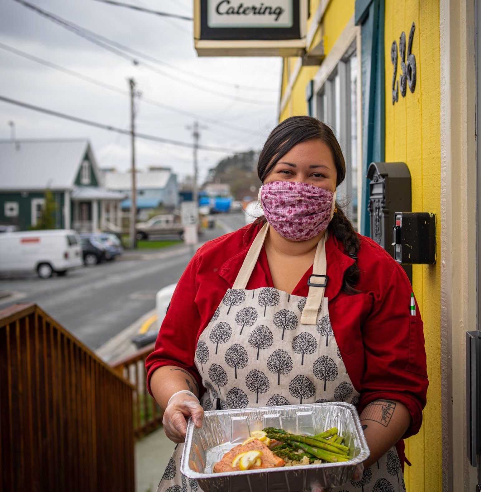 Edith Johnson holds a tray of coho salmon donated to Sitka Mutual Aid. Photo by Bethany Sonsini Goodrich.