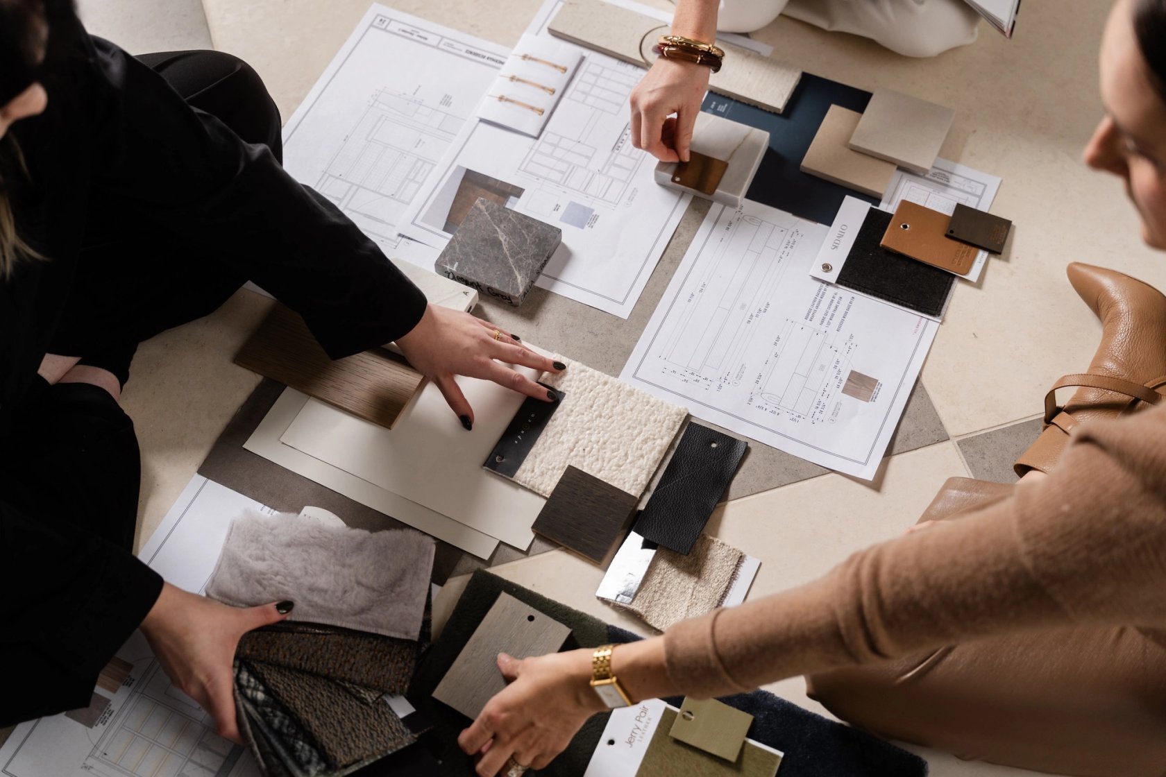Dawn Reeves Design Luxury Interior Design Chicago Illinois Designers Selecting Material Samples With Floor Plans