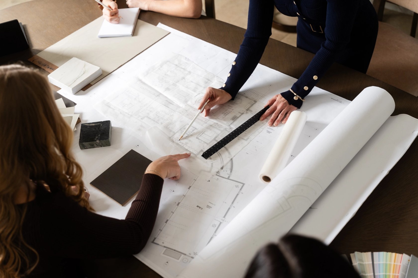 Dawn Reeves Design Luxury Interior Design Chicago Illinois Designers Reviewing Floor Plans With Swatches