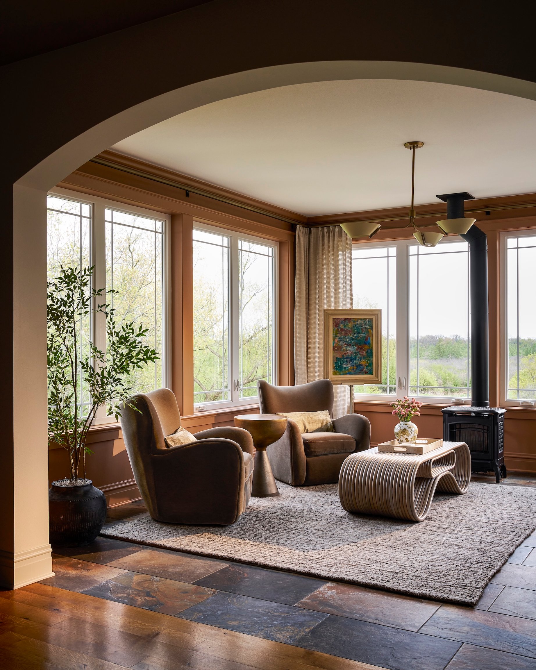 Dawn Reeves Design Luxury Interior Design Chicago Illinois Lake Geneva Sunroom Wood Stove Swivel Chairs