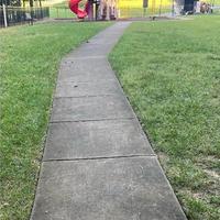 A View of the Sidewalk Heading Out of the Playground Full of Filth.