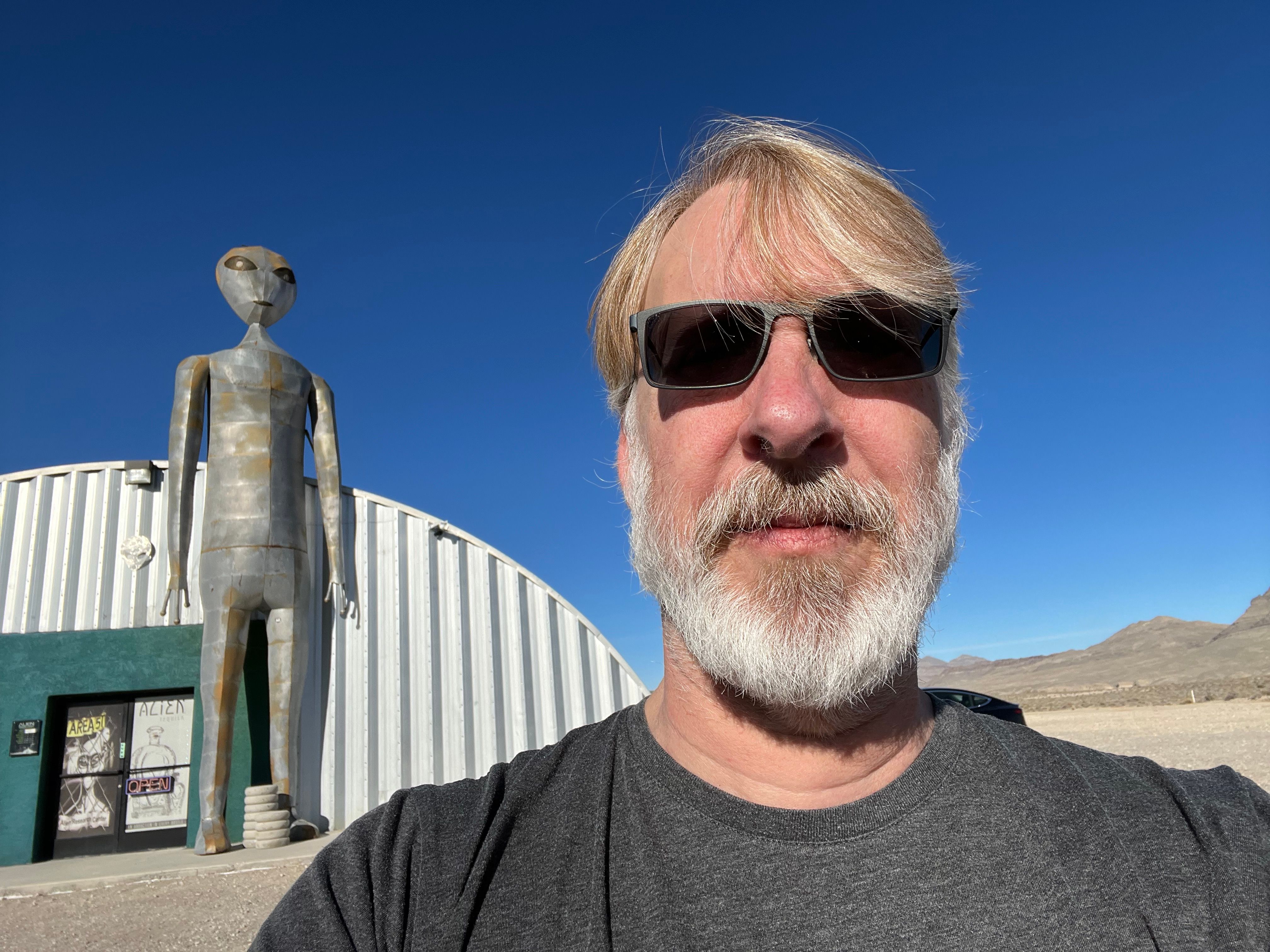 A selfie with Rusty Cole and a tall grey alien statue outside Area 51 in Nevada