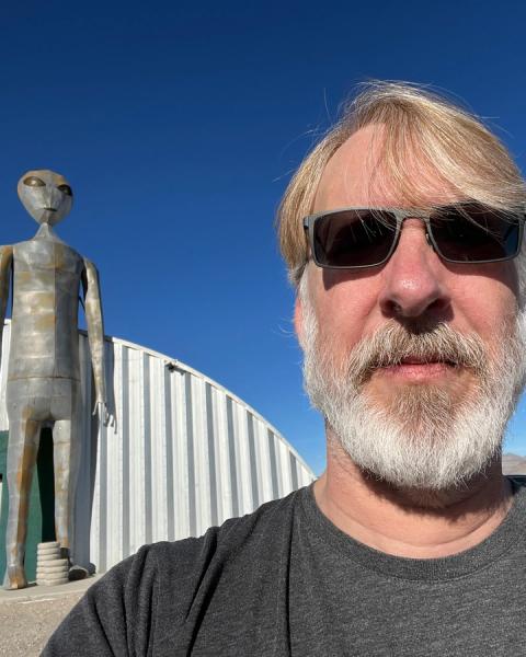 A selfie with Rusty Cole and a tall grey alien statue outside Area 51 in Nevada
