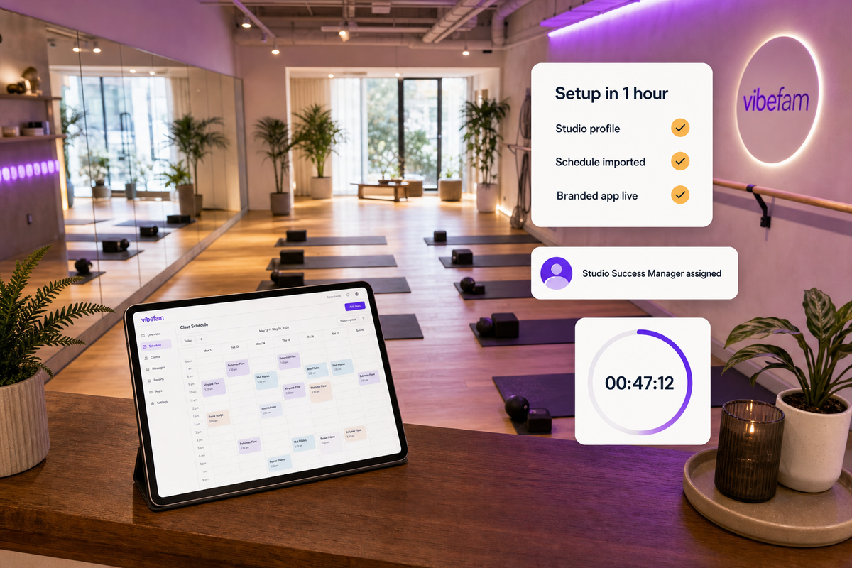 Modern boutique studio interior with a tablet showing the Vibefam class schedule on a wood counter, floating UI cards showing the 1-hour setup checklist, dedicated Studio Success Manager assignment, and a 47-minute setup countdown