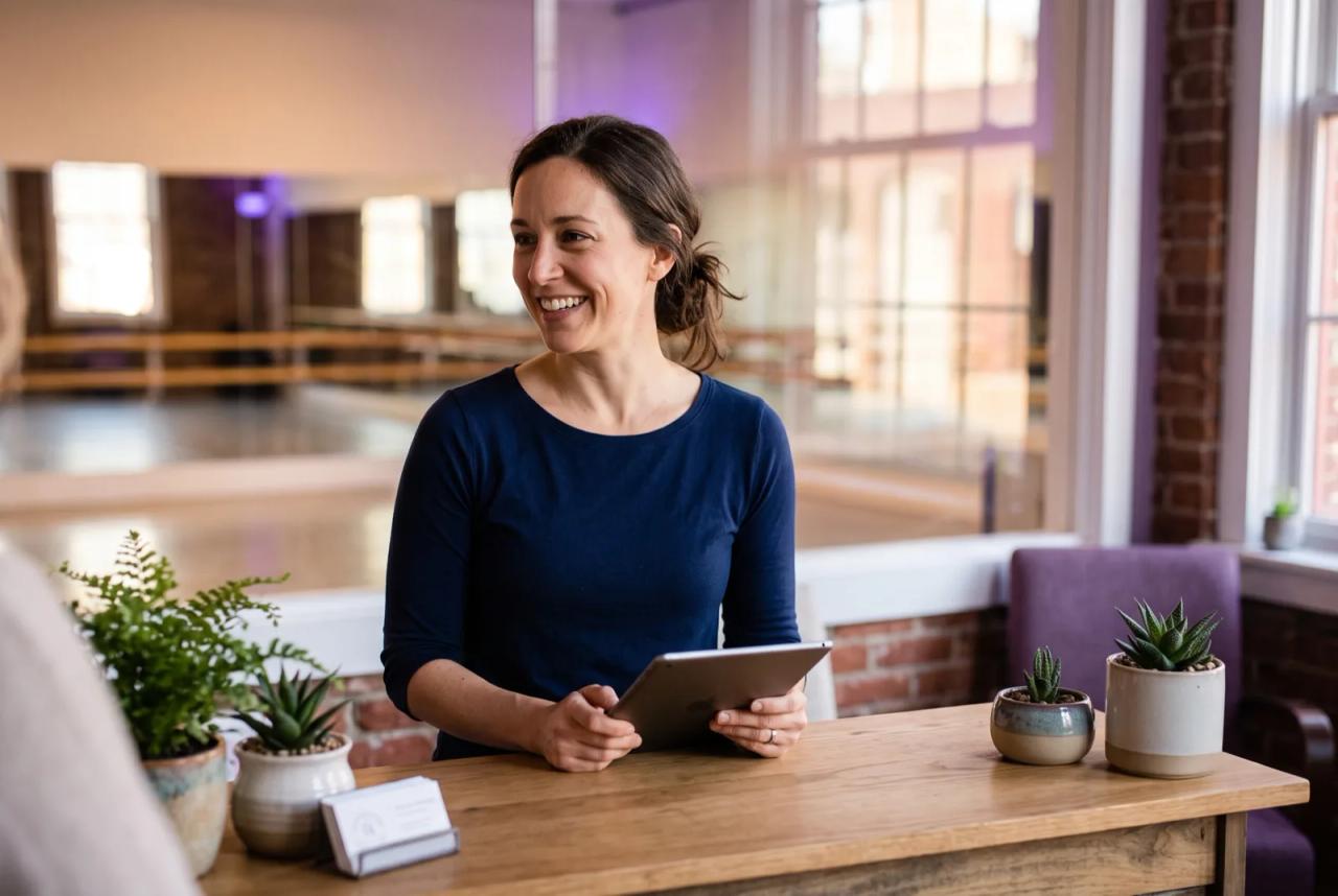 A dance studio owner managing enrollment on a tablet