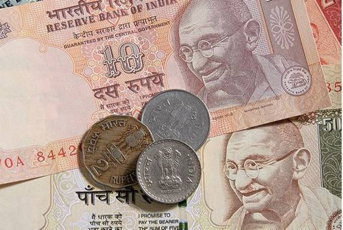 Indian rupee banknotes and coins featuring Gandhi