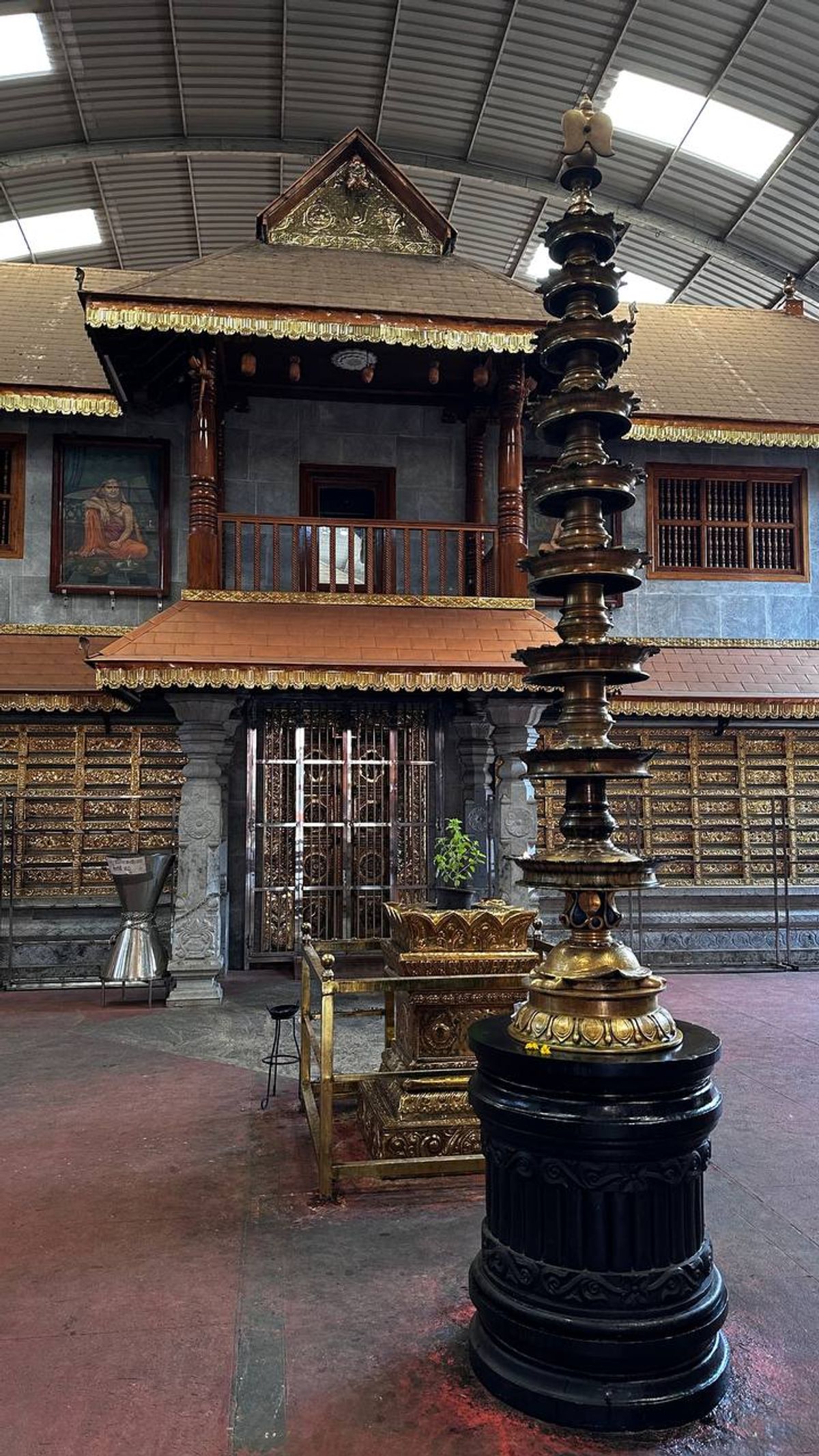 Ornate temple interior with brass lamp