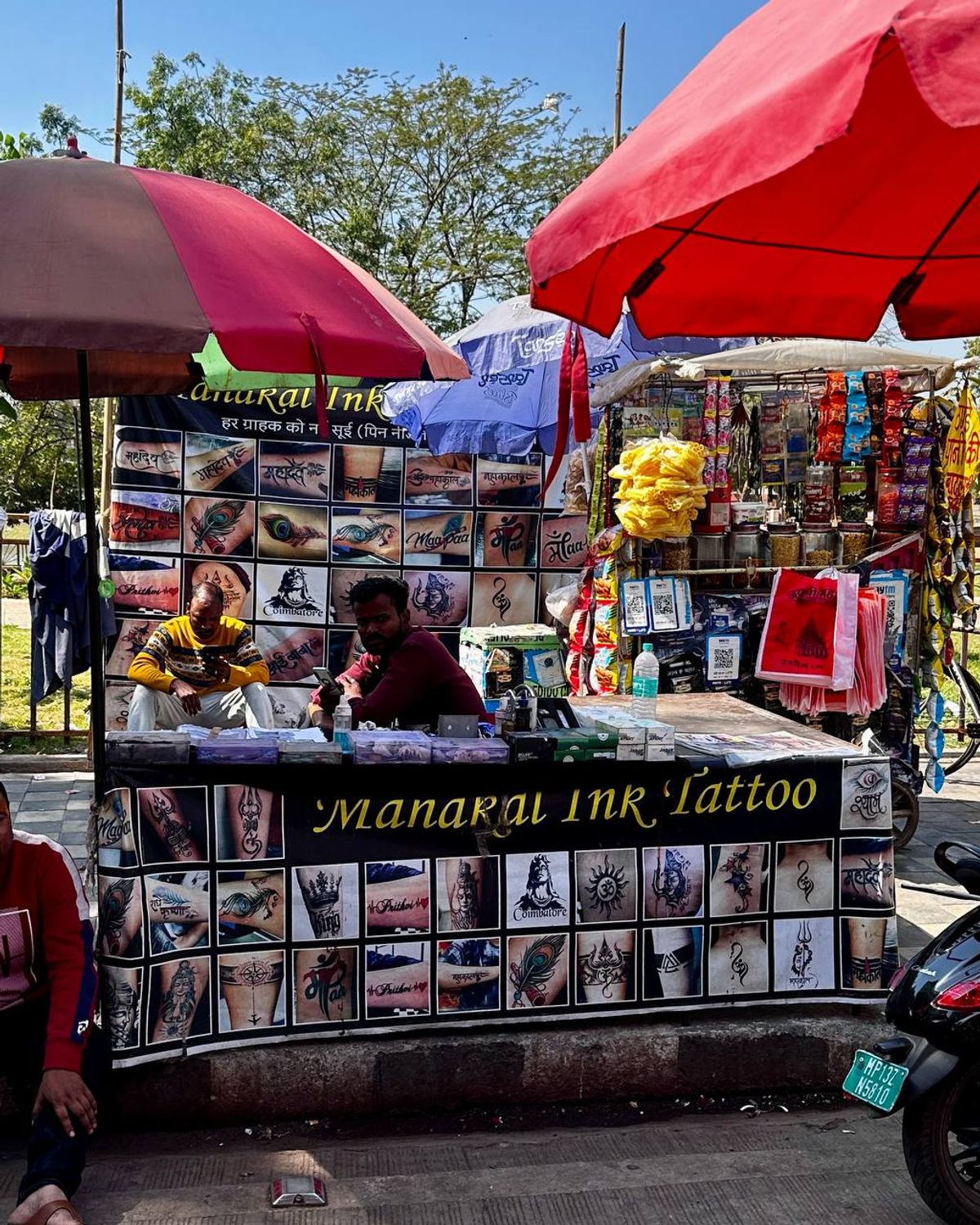 Street tattoo stall with religious designs