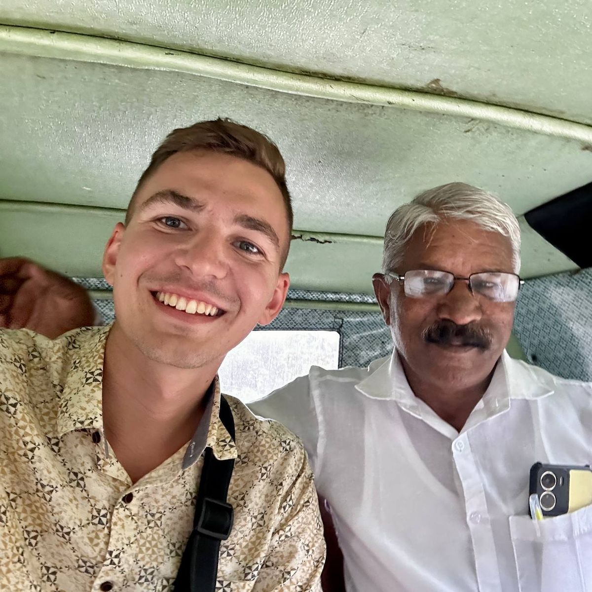 Author with party functionary in auto-rickshaw