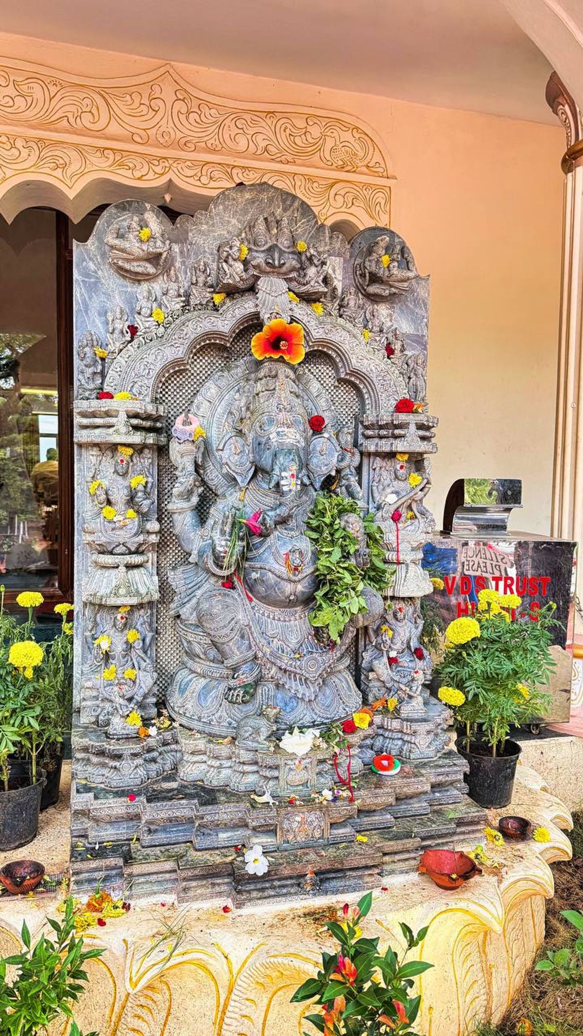 Ornate Ganesha statue with flower offerings