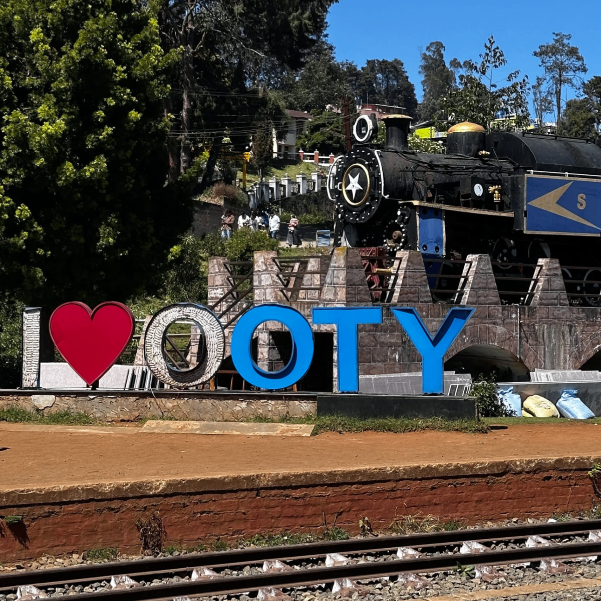 I Love Ooty sign with vintage steam locomotive in background