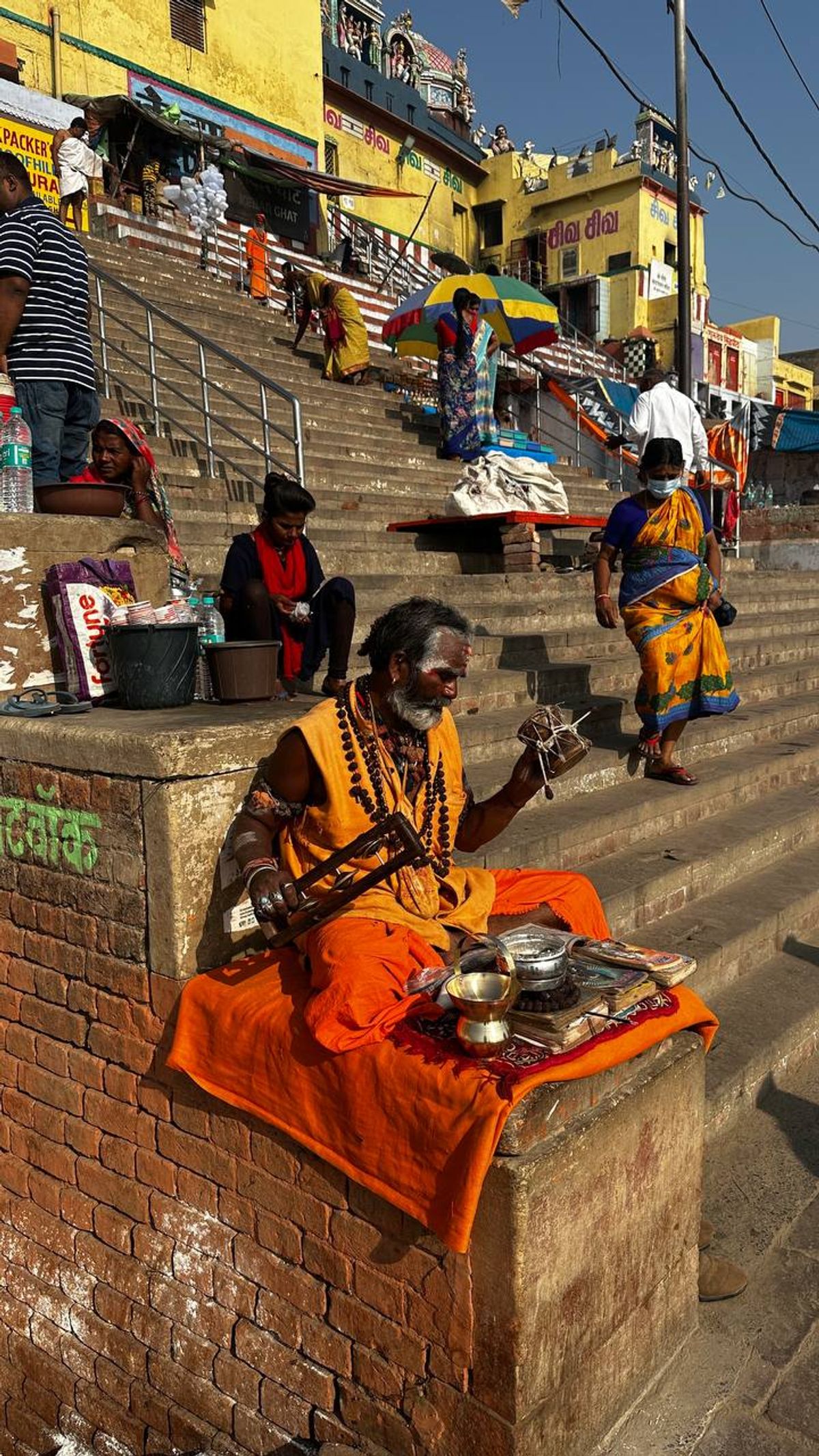Sadhu musician on temple ghats
