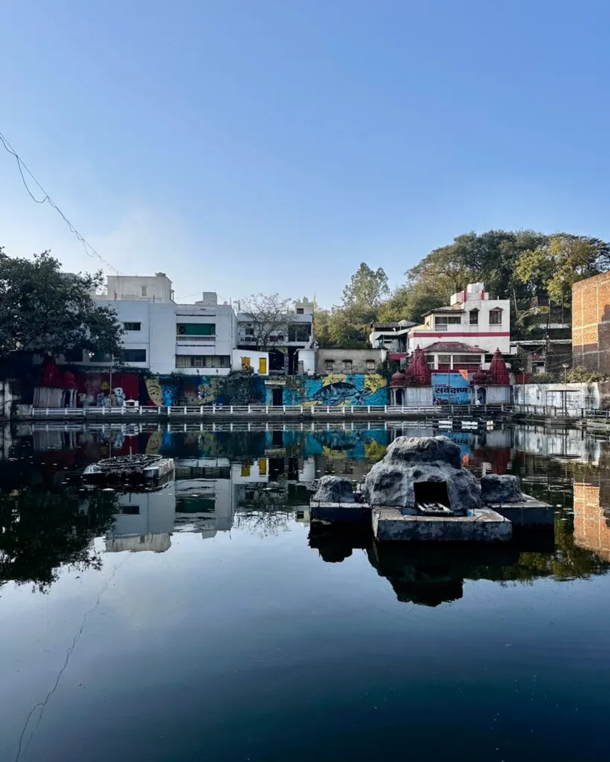 Sacred pond in Ujjain with temple reflections