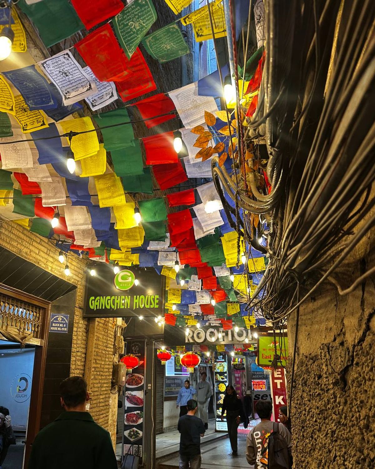 Colorful prayer flags strung across narrow lanes of Majnu Ka Tilla