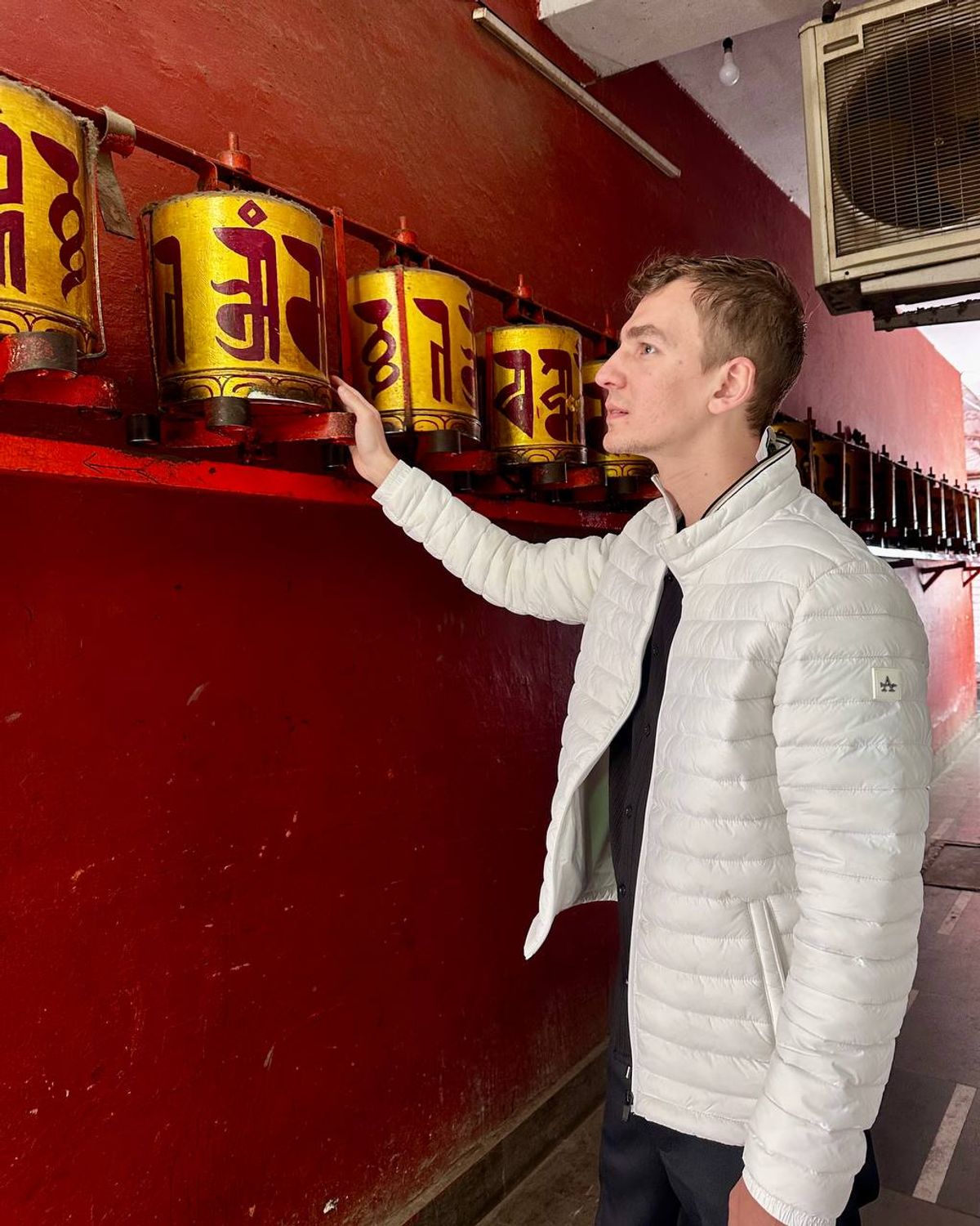 Spinning traditional Tibetan prayer wheels at the monastery