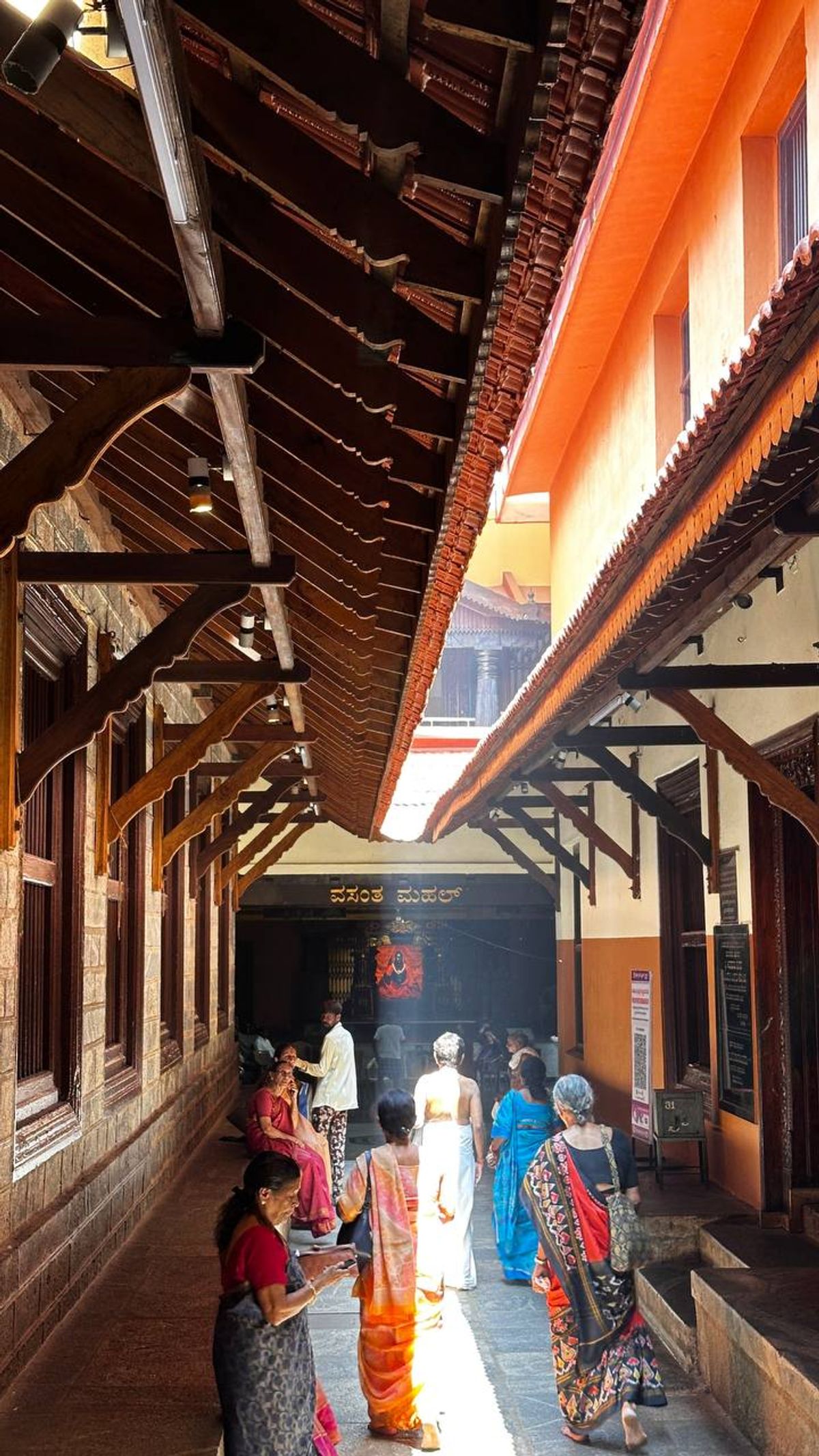 Temple corridor with devotees in colorful saris