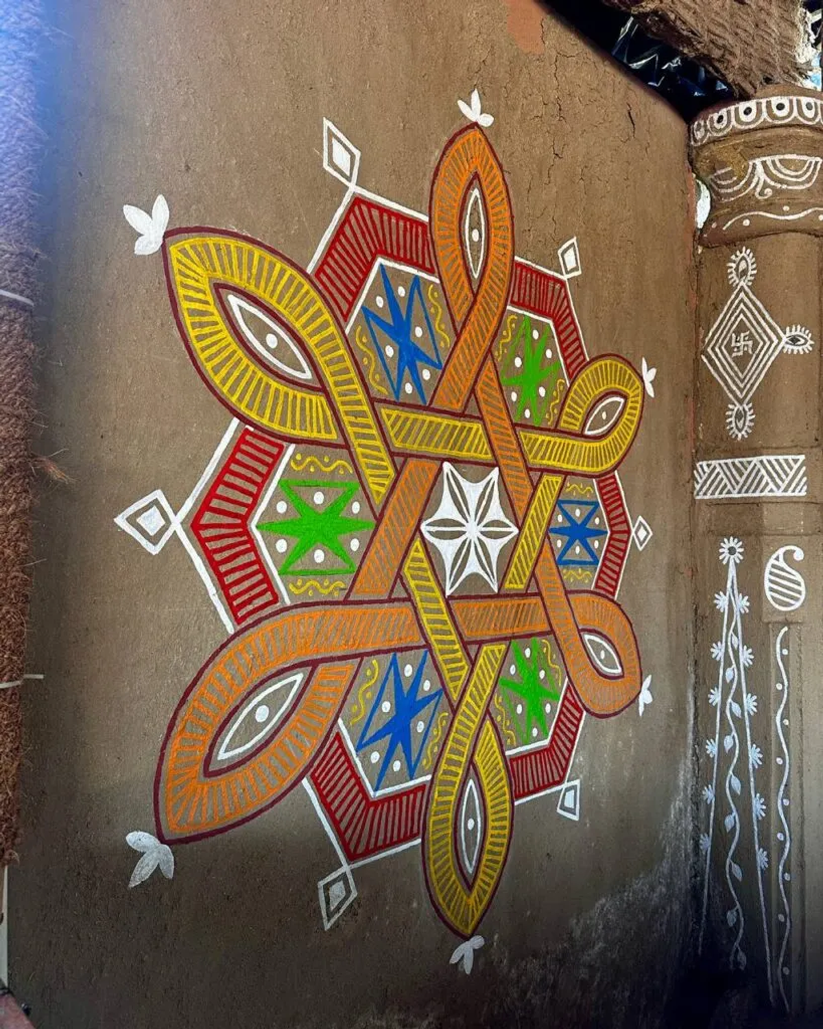 Traditional kolam art on ashram walls
