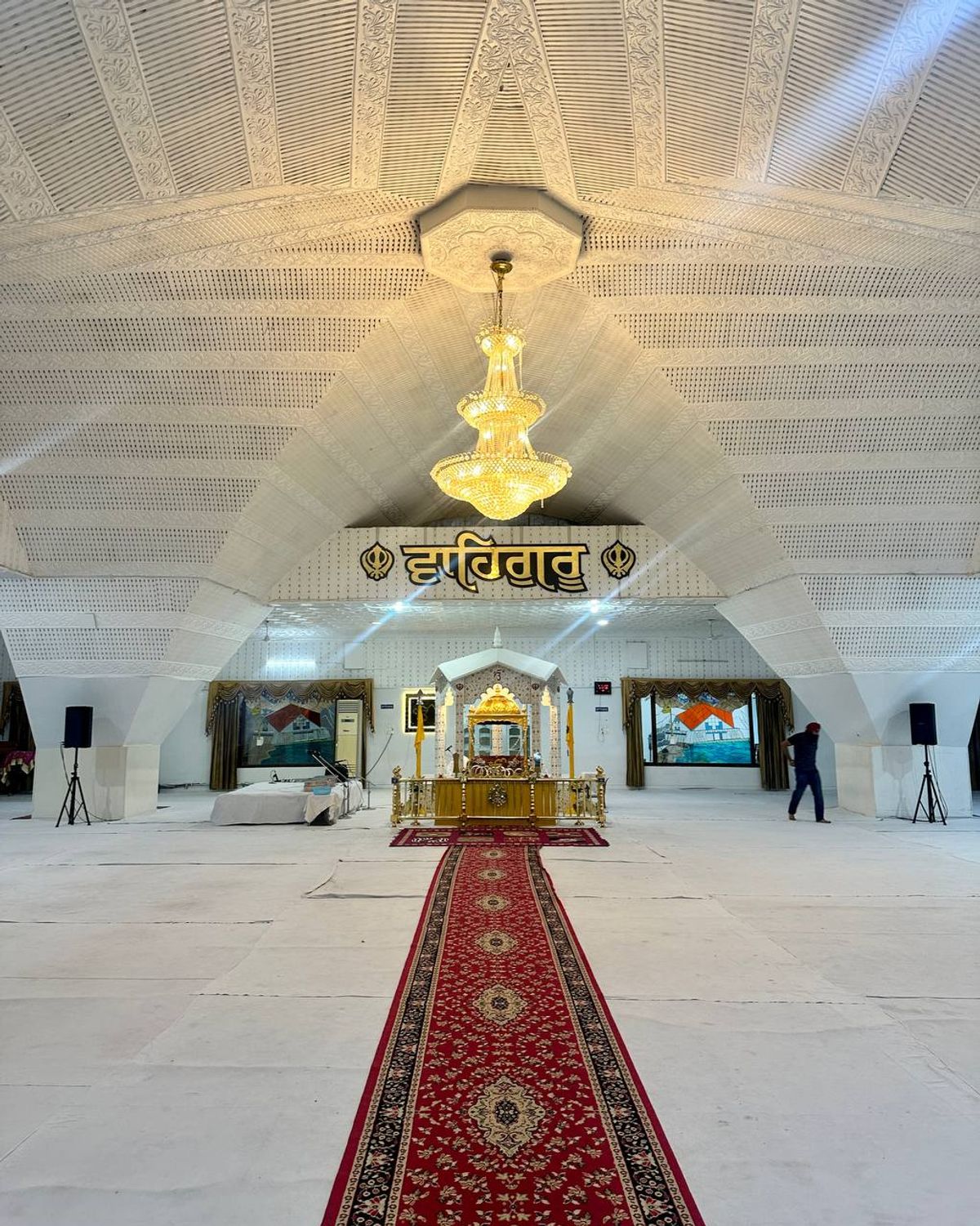Gurdwara prayer hall interior with chandelier