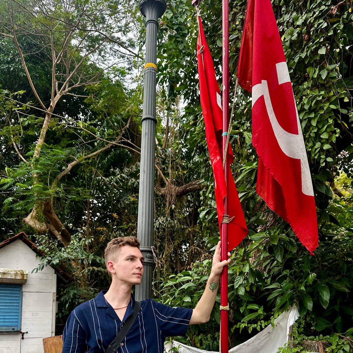 Author standing with communist red flags