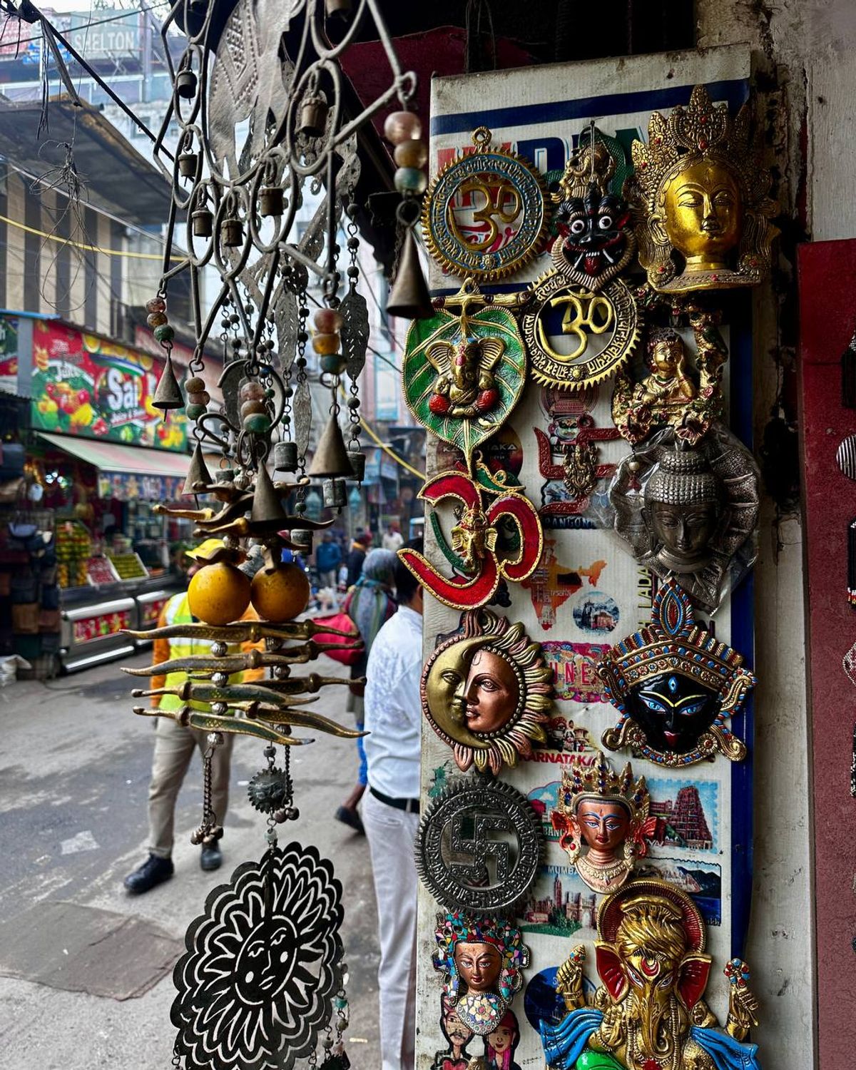 Colorful Indian souvenirs including Om symbols and Ganesh statues