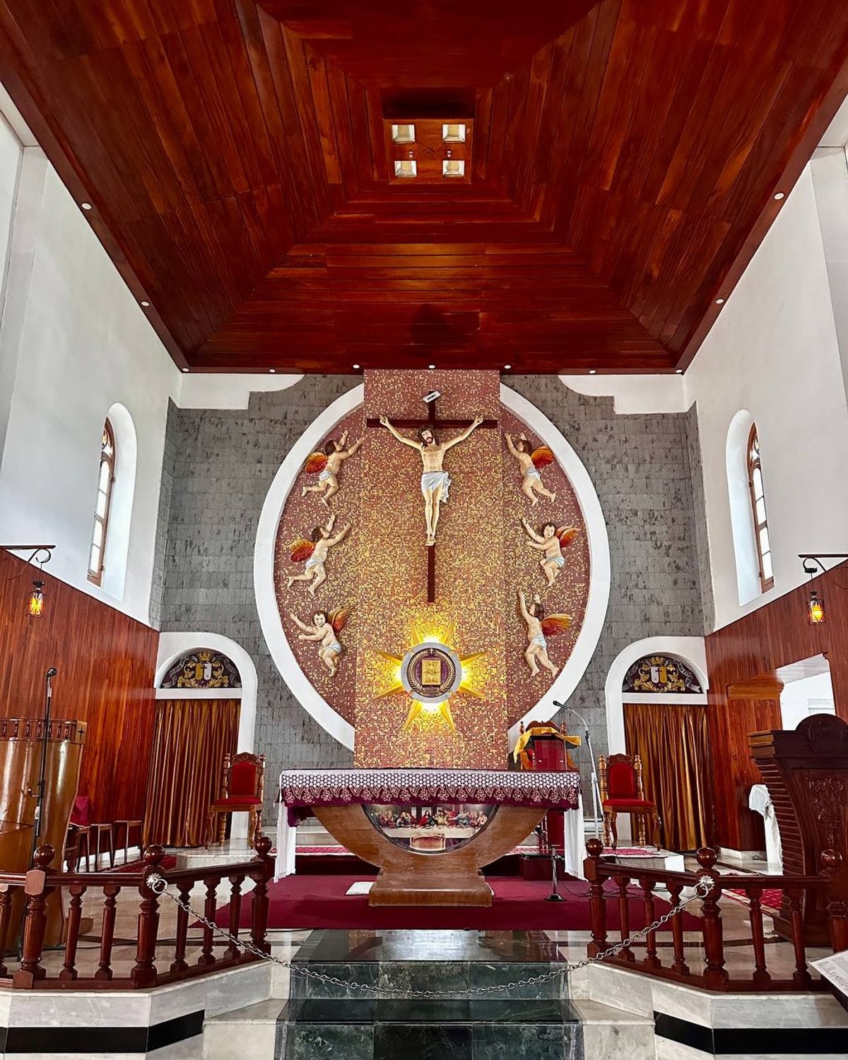 Modern church altar with crucifix and wooden ceiling