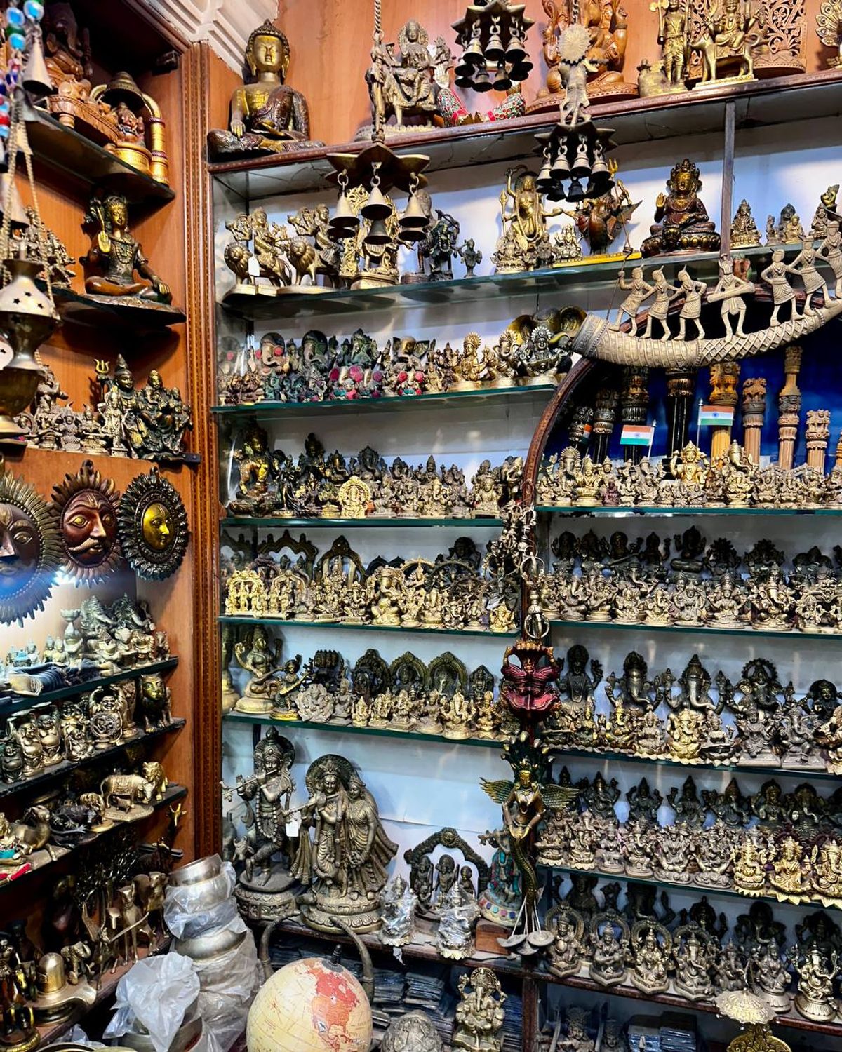 Shelves filled with brass Hindu deity statues