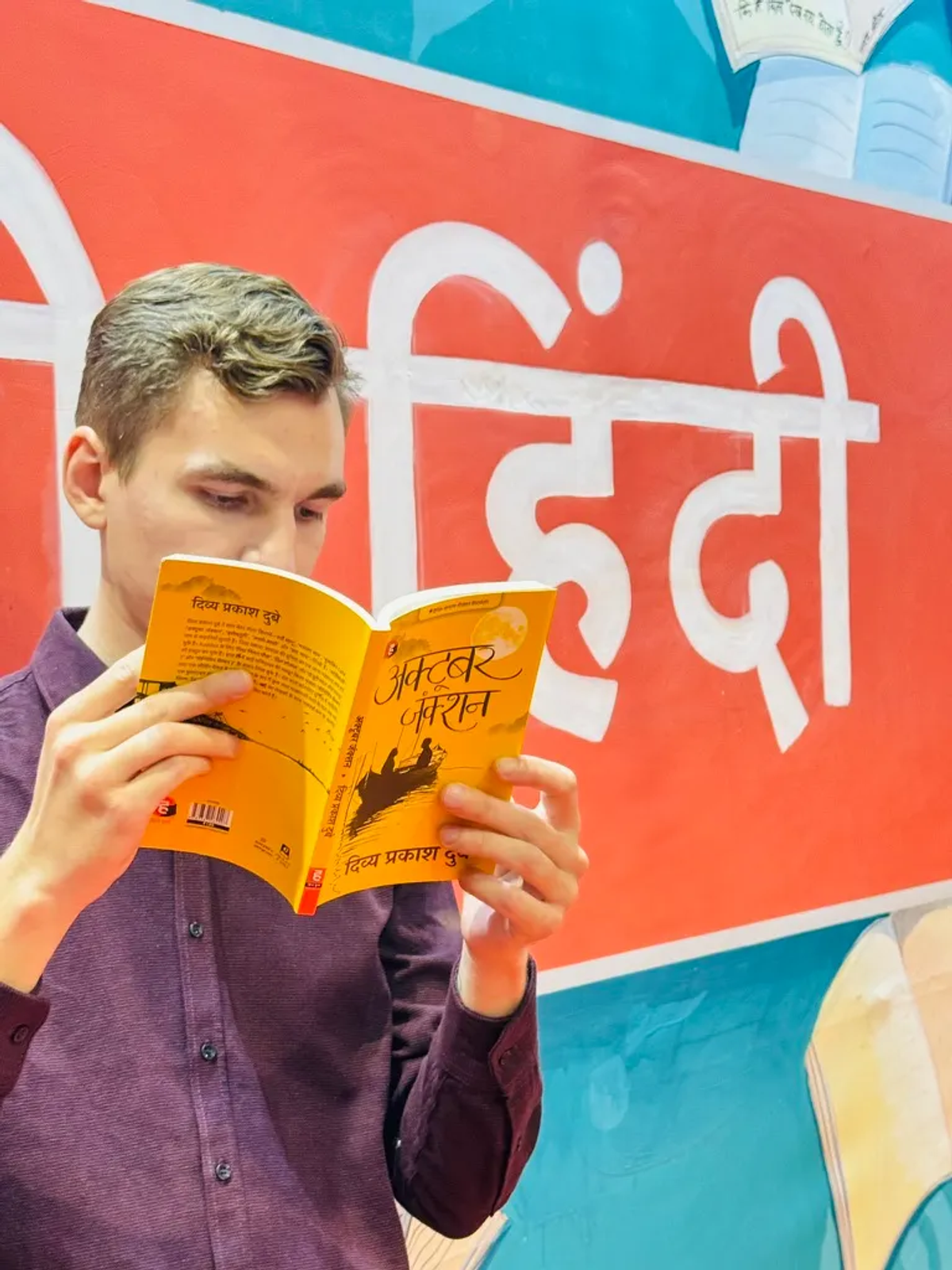 Reading a Hindi book at the Delhi Book Fair