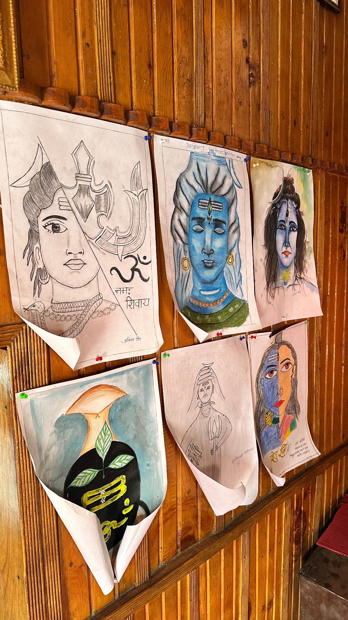 Hand-drawn Shiva art on a wooden wall