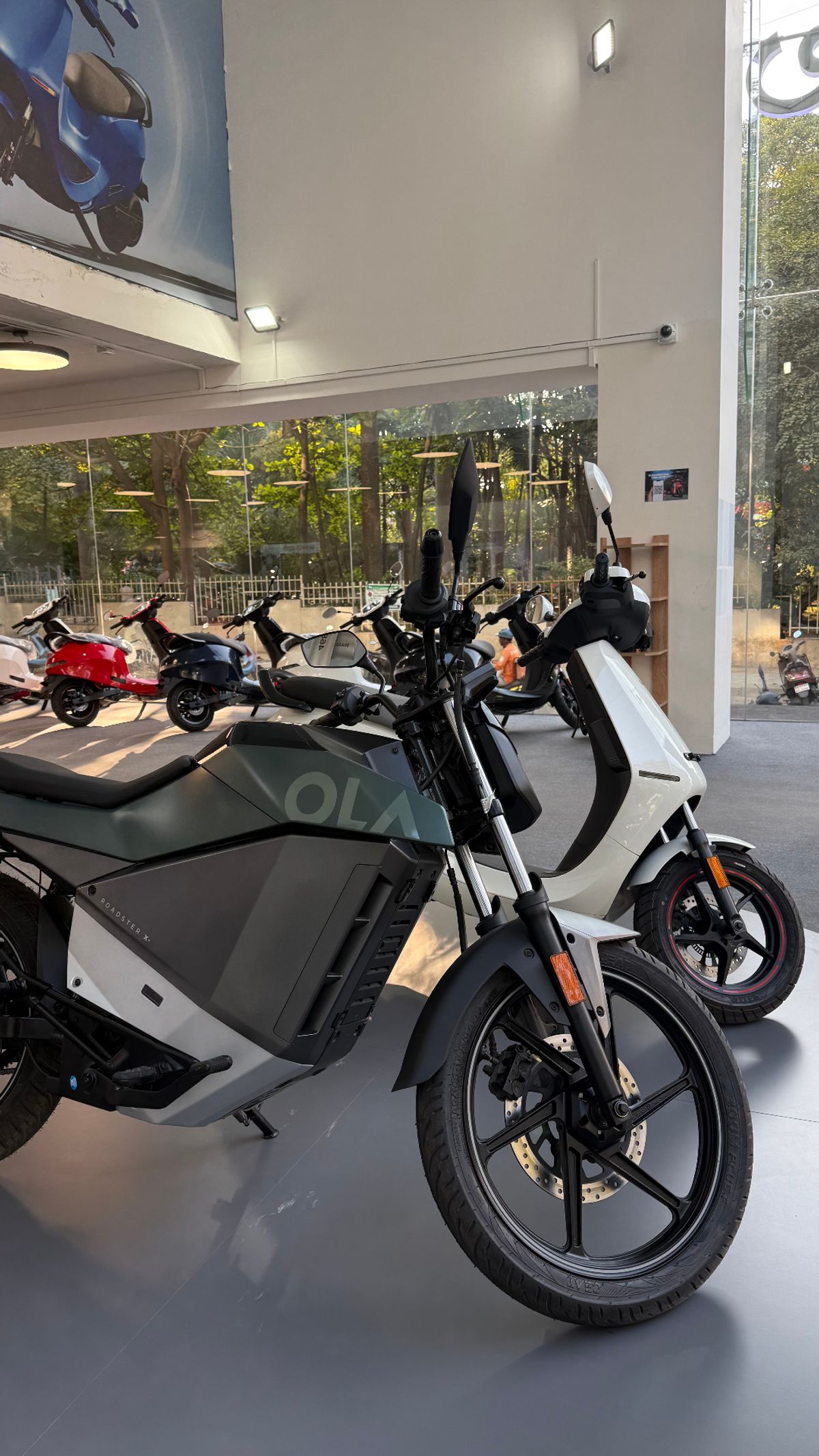 Ola Roadster X and electric vehicles displayed in showroom