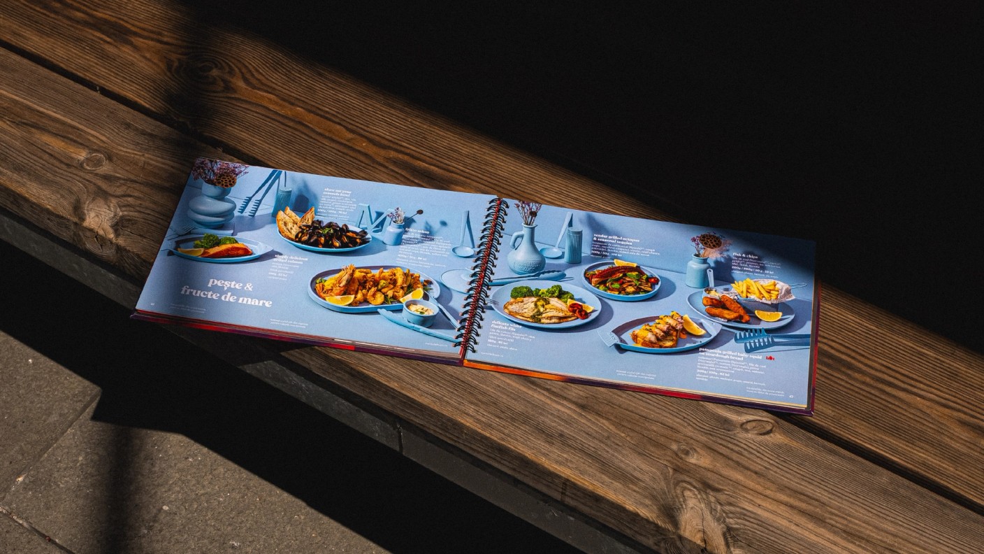 Open Marty Restaurants menu displaying plated dishes on a wooden bench