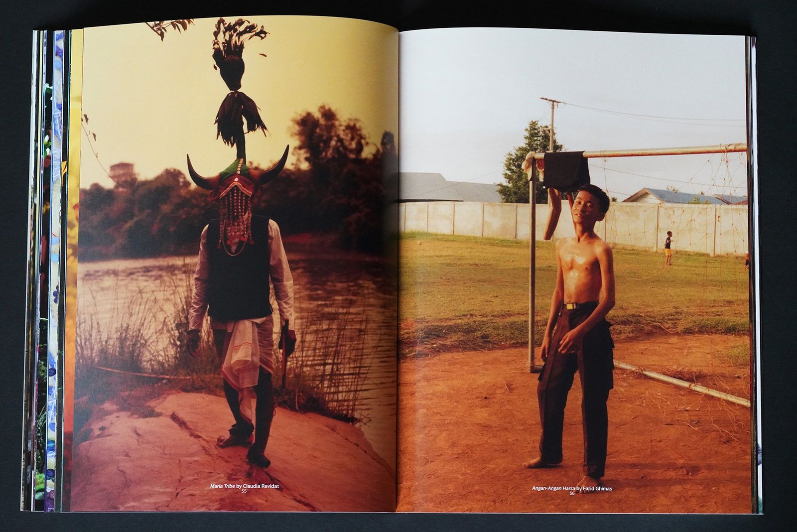 An open book spread: a masked figure with horns and a feathered headdress beside a river, and a shirtless boy standing by a goalpost.