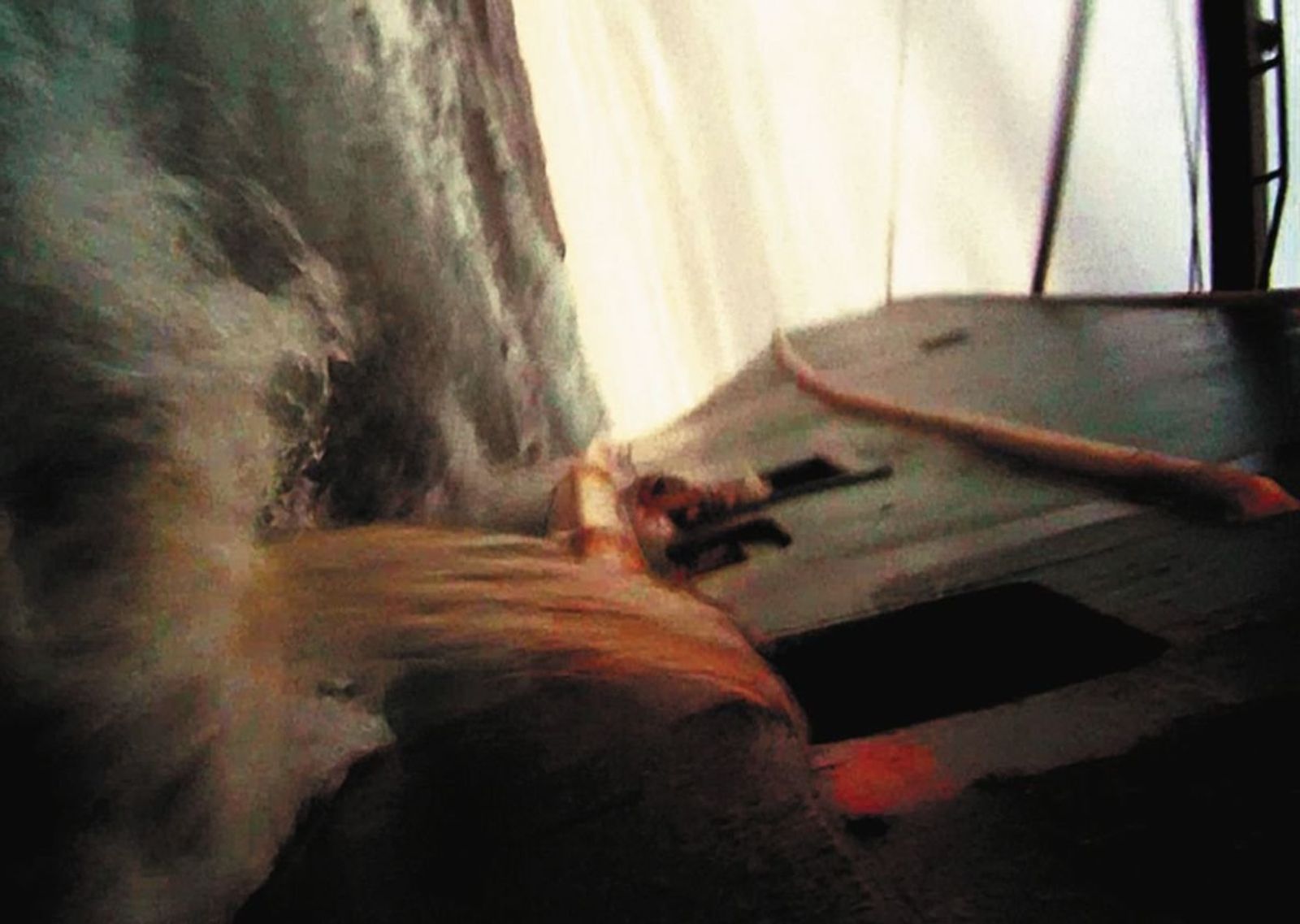 Dark, blurred film still of a wave breaking over the deck of a fishing boat.