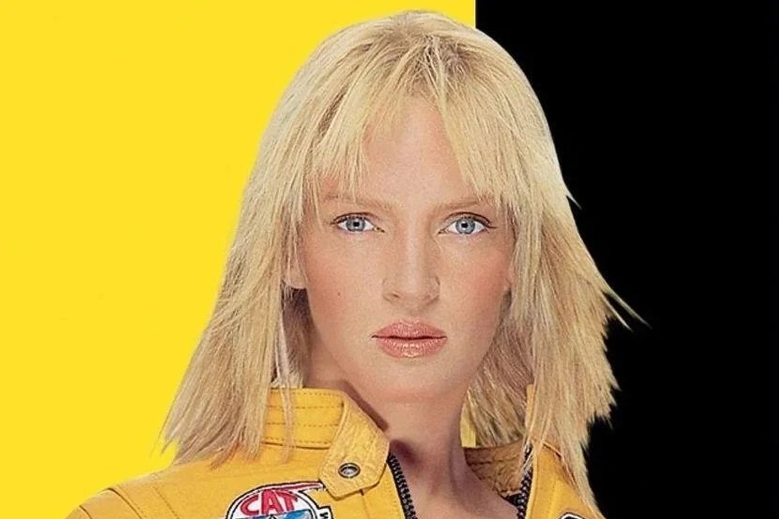 Close-up of a blonde woman with blue eyes in a yellow biker jacket, against a split yellow and black background.