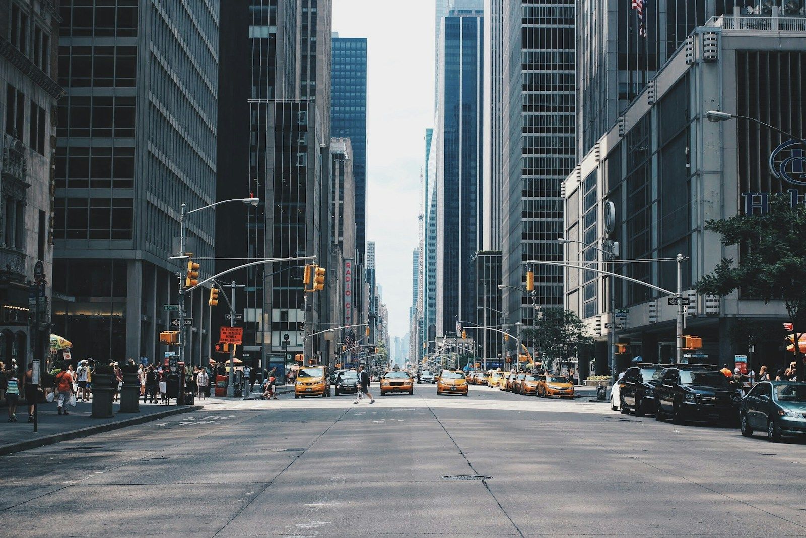 People crossing a busy urban intersection in motion blur