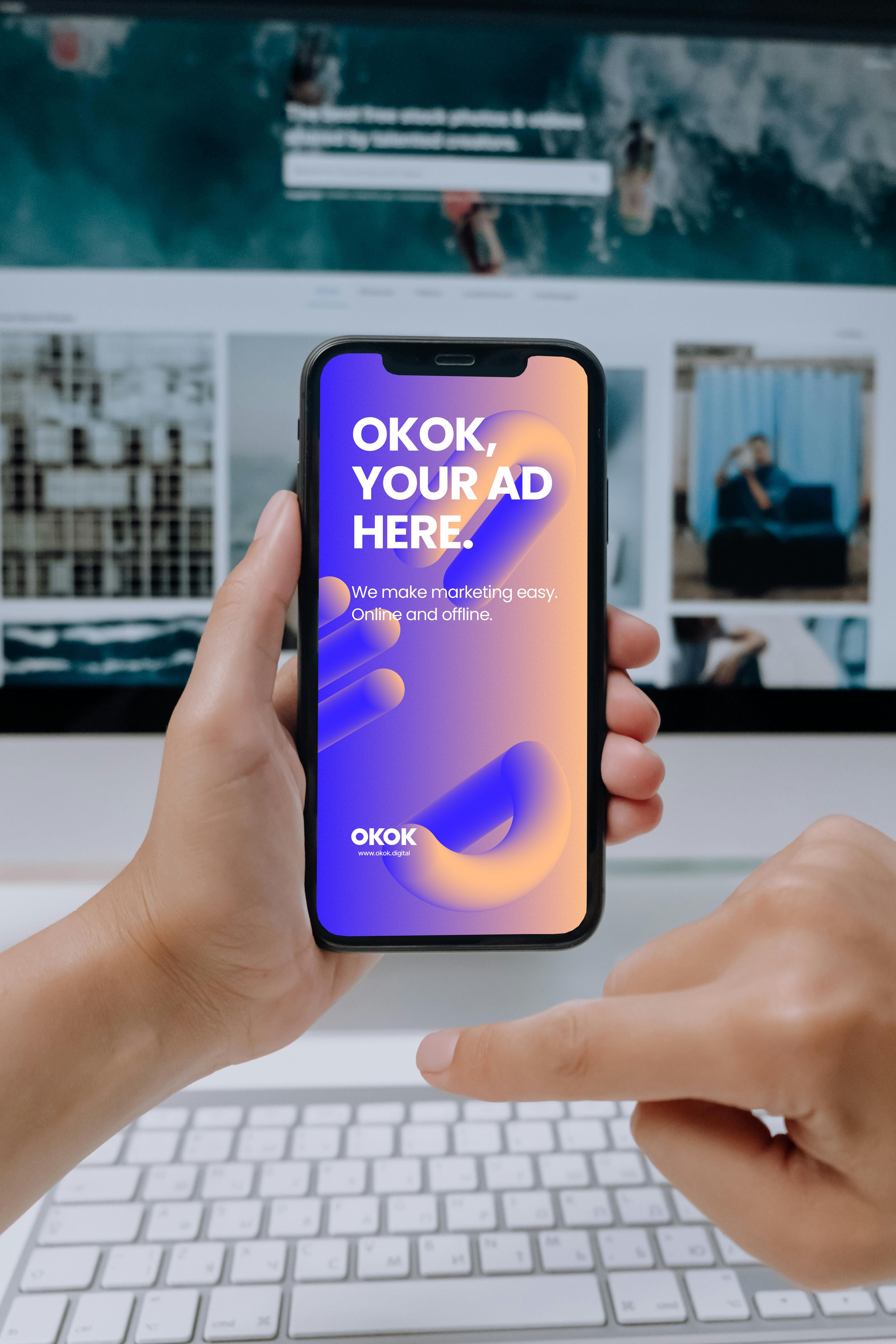 Hands holding a smartphone showing an ad mockup