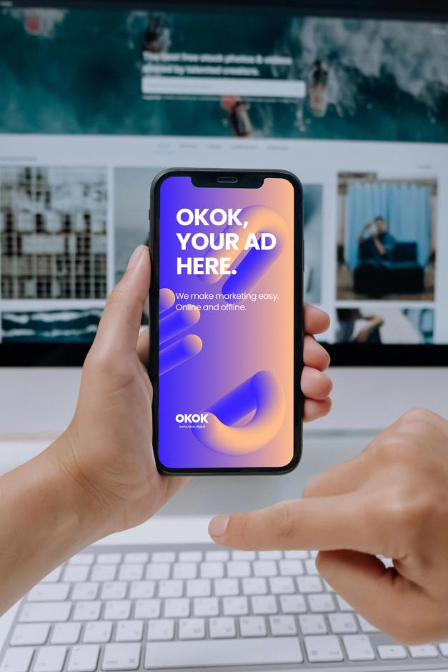 Hands holding a smartphone showing an ad mockup