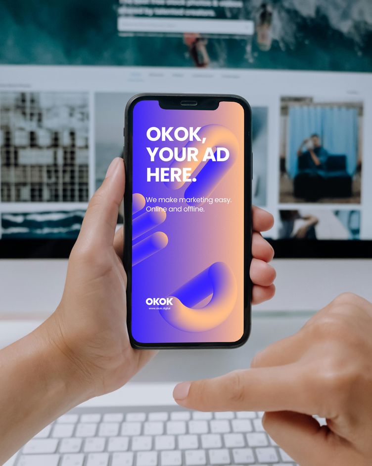 Hands holding a smartphone showing an ad mockup