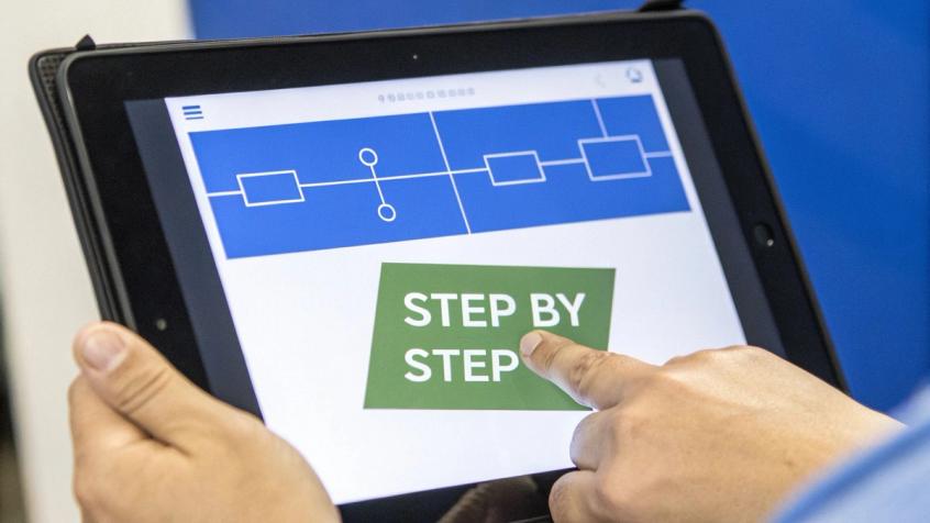 An illustration showing a chatbot conversation with progressive disclosure, where the bot reveals options one step at a time, simplifying the user's choices.