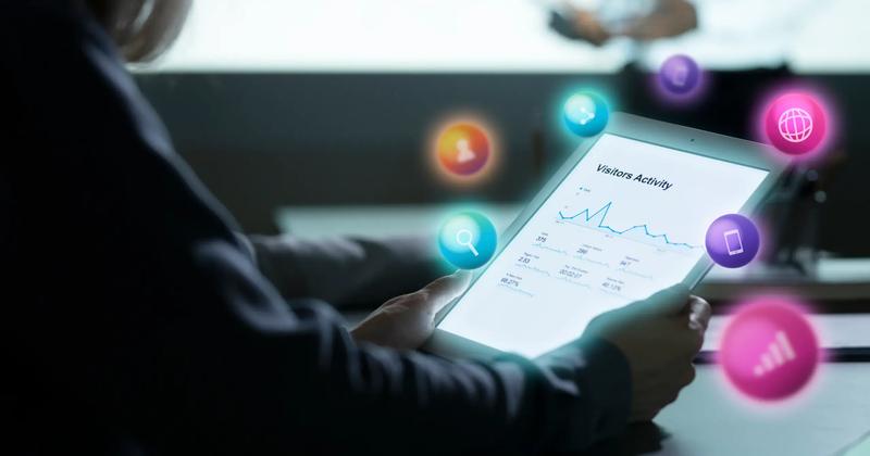 A person analyzing visitor activity data on a tablet, representing digital marketing insights. Conceptual icons illustrate what is affiliate marketing, online marketing strategies, and digital growth.