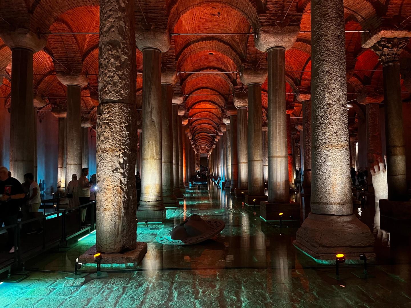 Rows of illuminated columns reflected in the water inside the Basilica Cistern