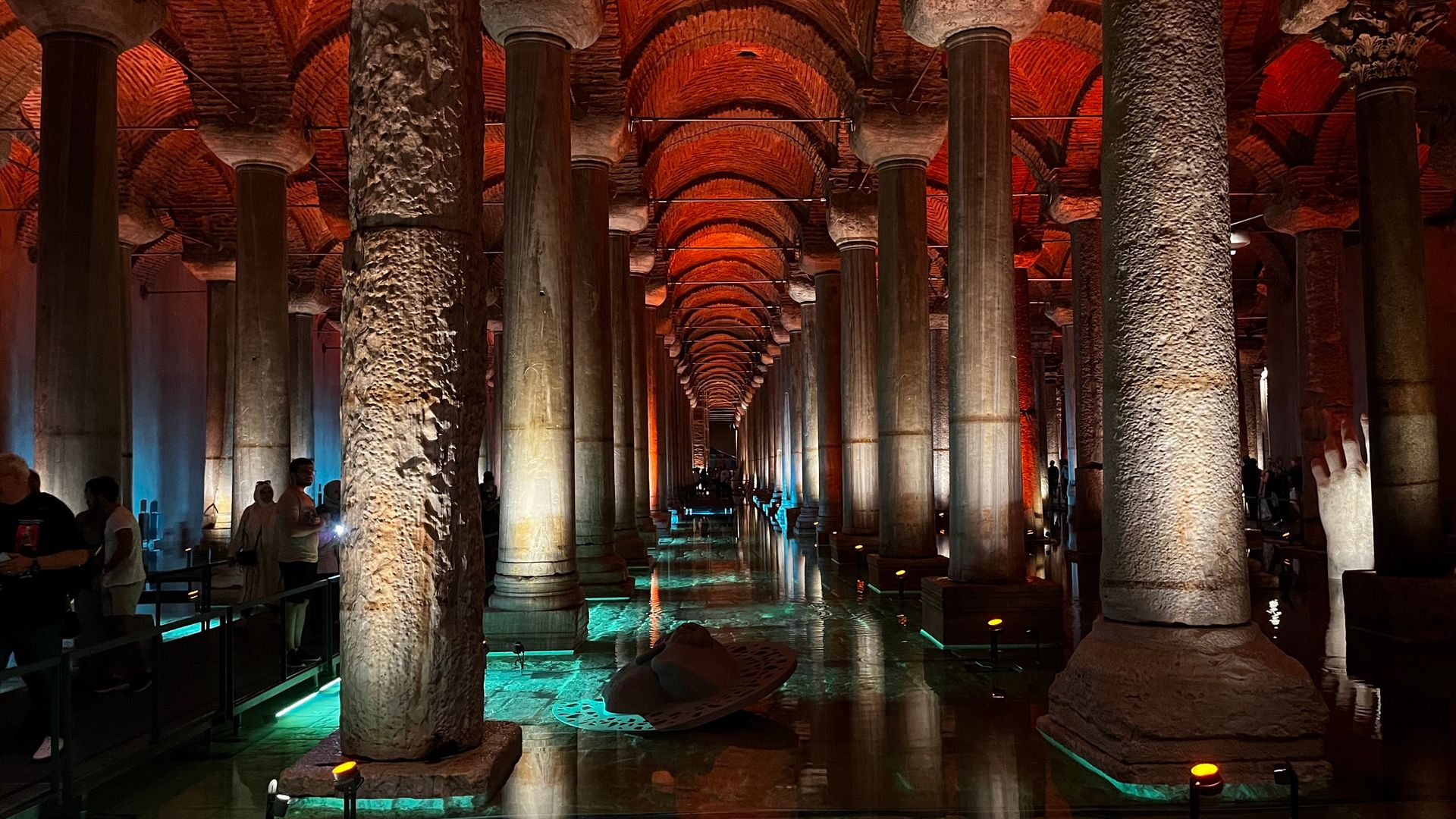 Rows of illuminated columns reflected in the water inside the Basilica Cistern