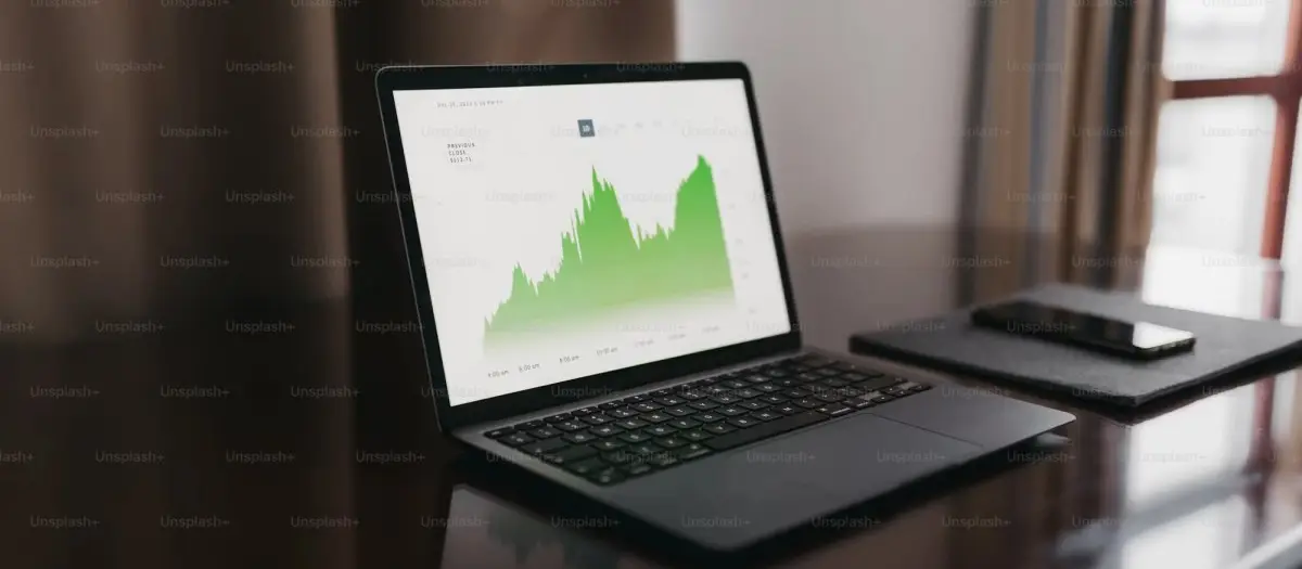 Open laptop on a desk displaying business growth metrics