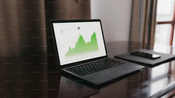 Open laptop on a desk displaying business growth metrics