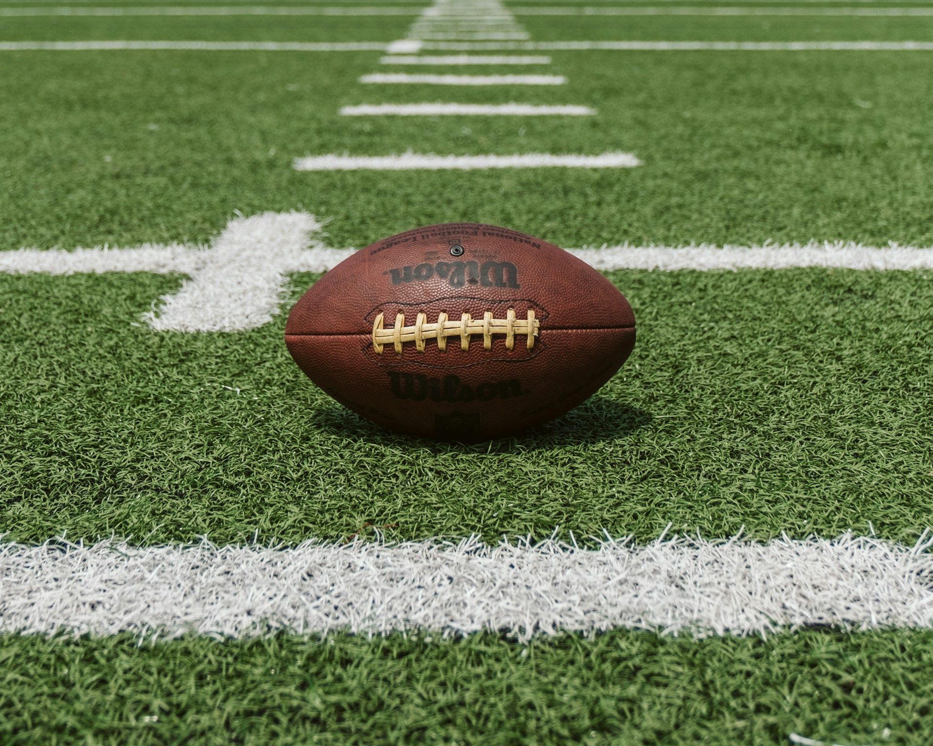 Football resting on a football field
