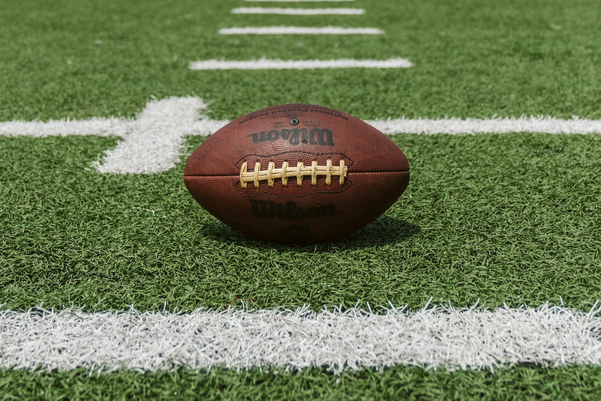 Football resting on a football field