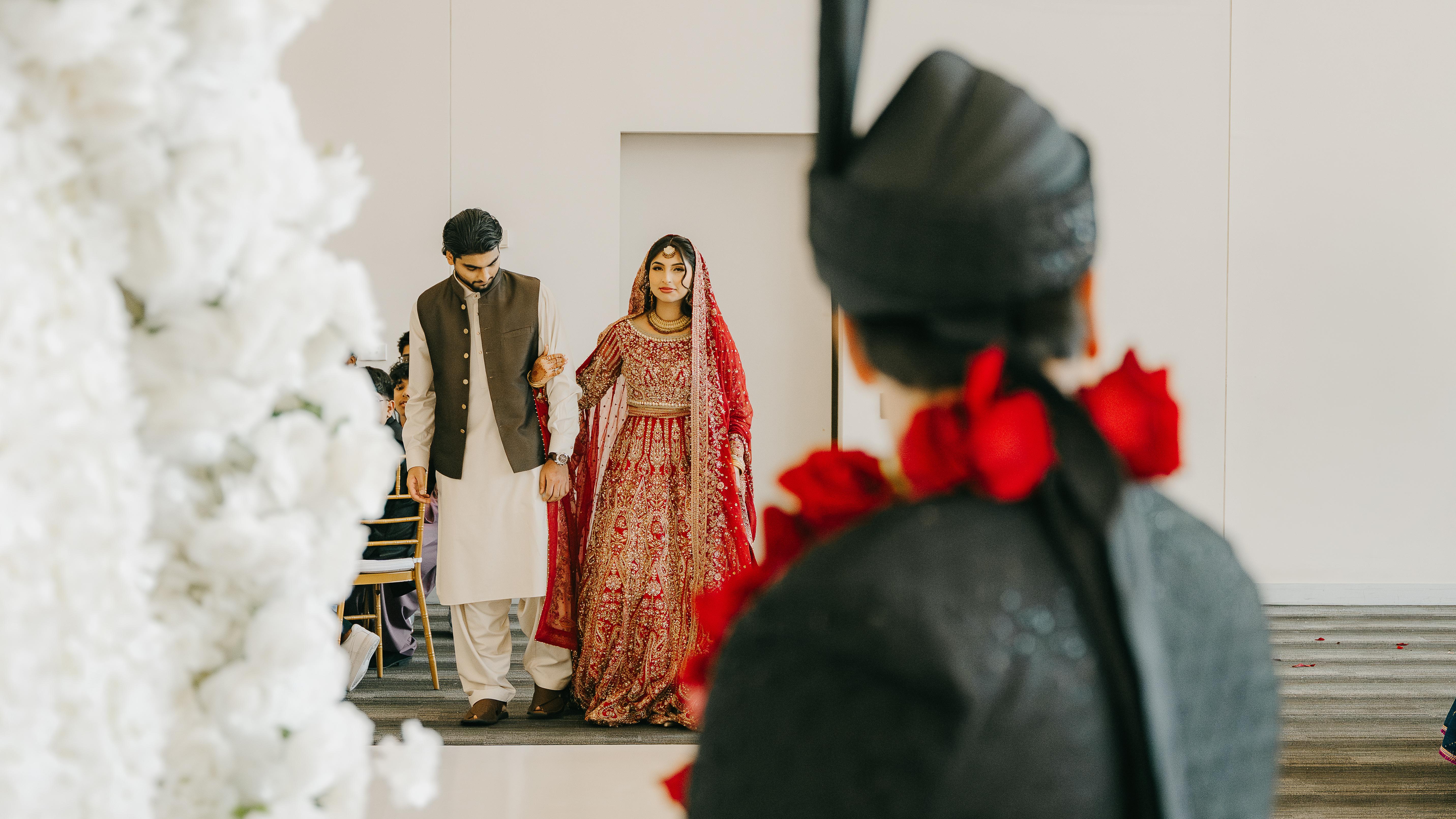 A groom waiting his bride walking towards hiim