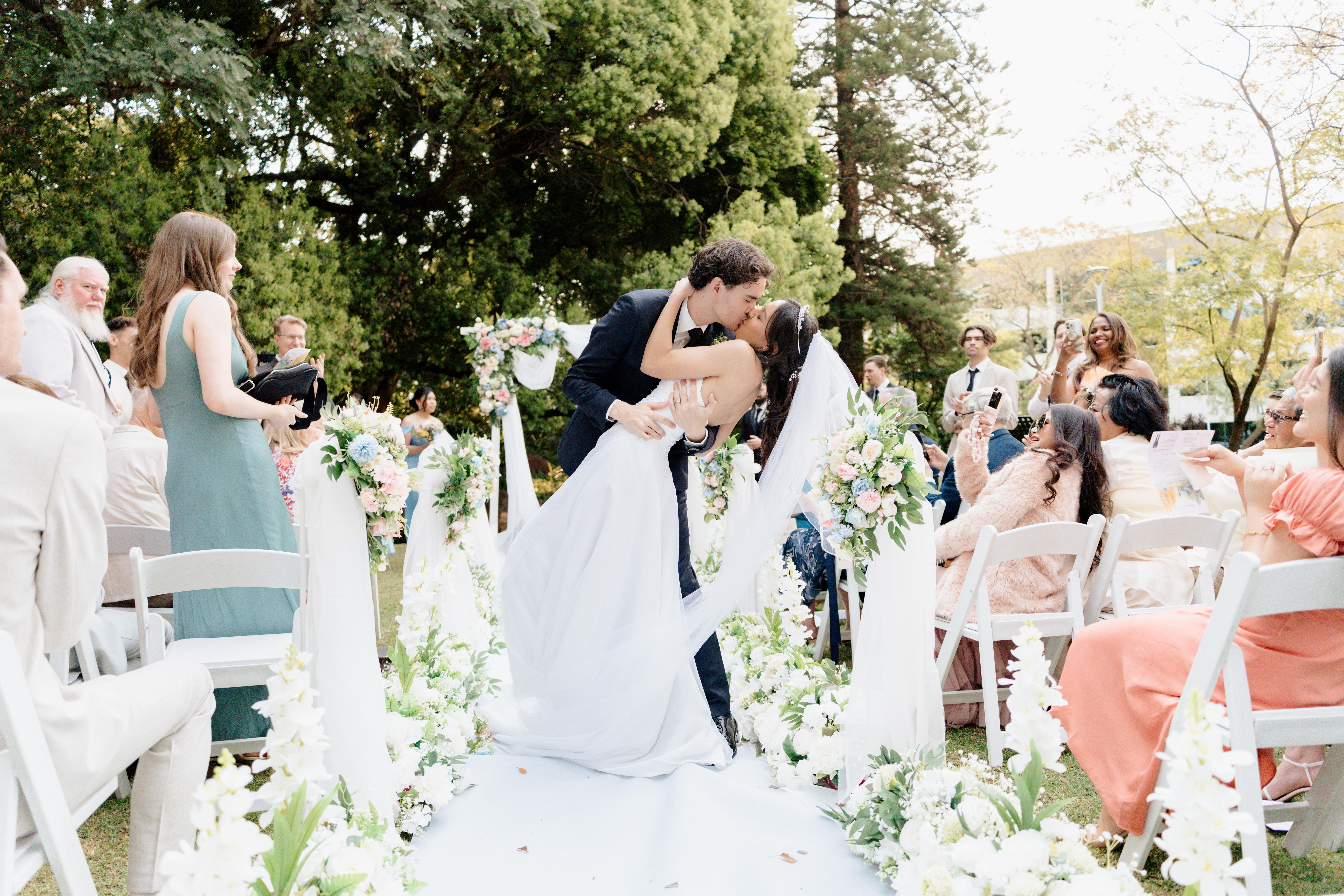 Newly wed husband and wife kissing scene